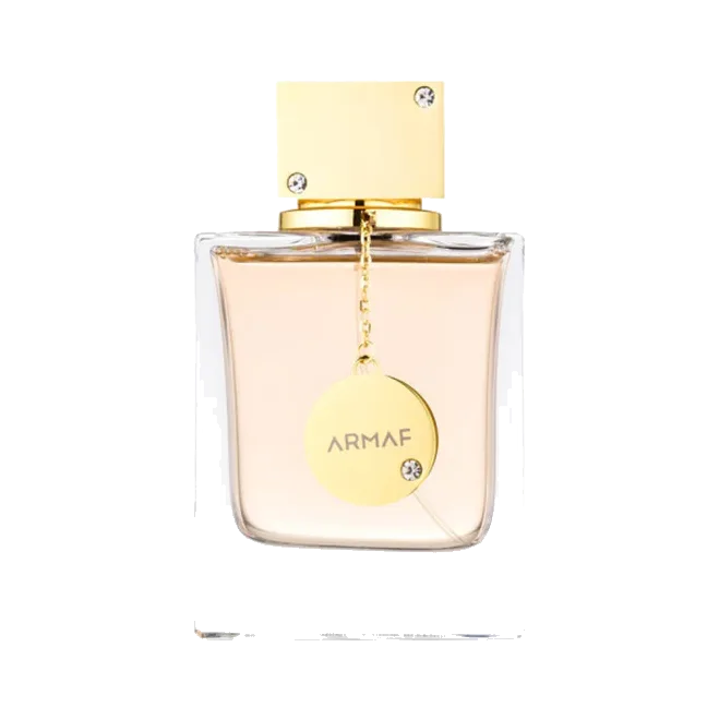 Frasco rectangular de vidrio transparente con líquido rosa durazno, tapa dorada con cristales y un medallón dorado colgando, sobre fondo blanco.