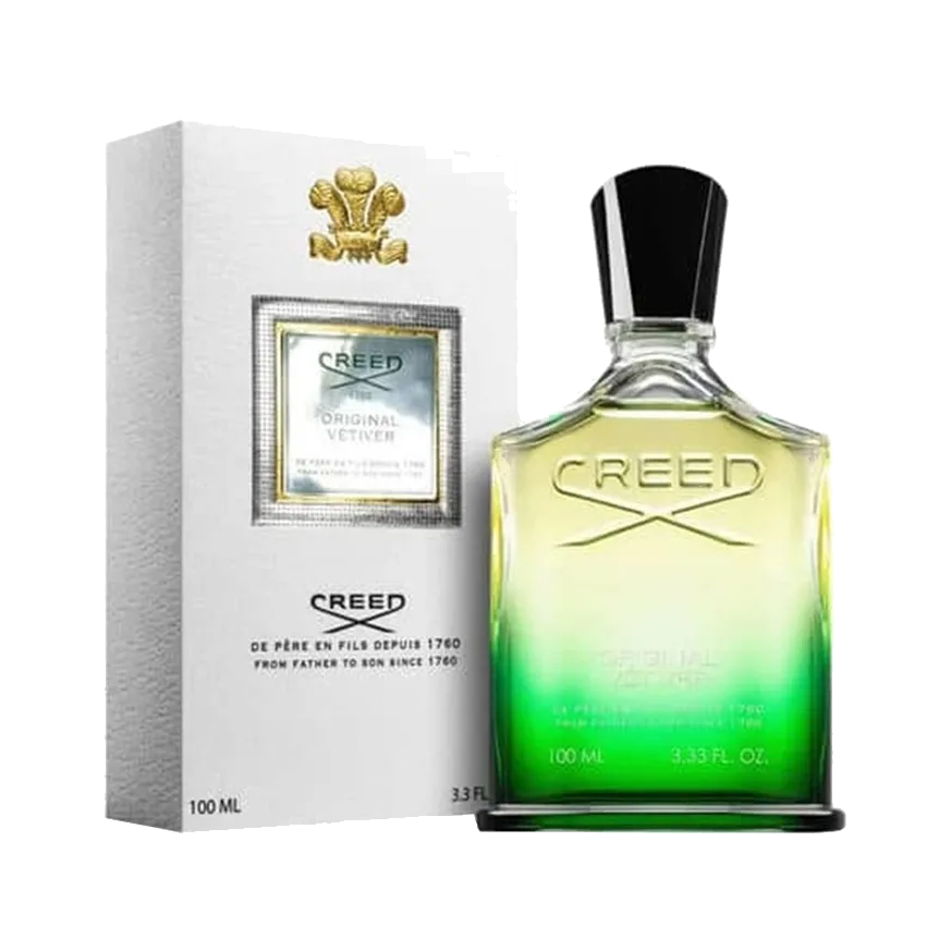 Frasco de hombros caídos con degradado de amarillo pálido a verde, nombre grabado y tapón negro, junto a su estuche blanco con escudo dorado, sobre fondo blanco.