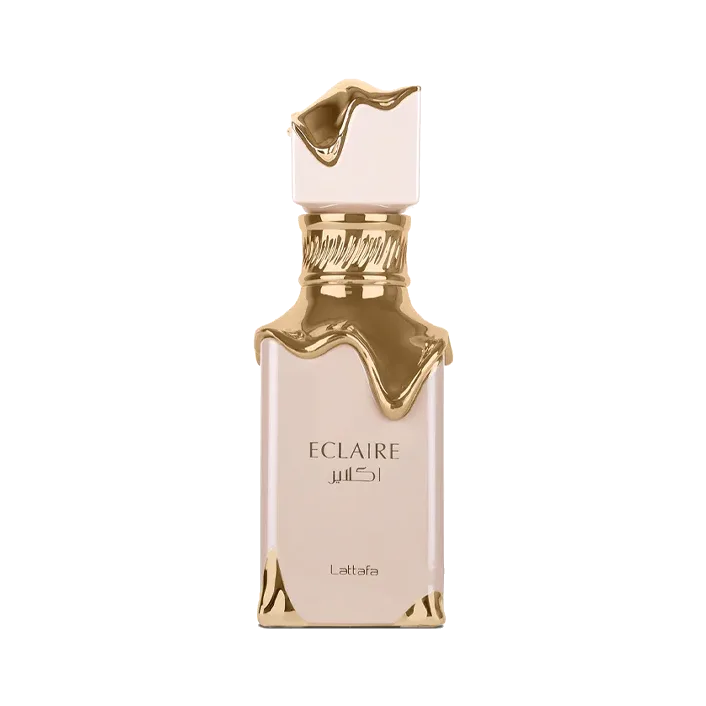 Frasco rectangular rosa empolvado con un chorreado de metal dorado que baja desde la tapa como glaseado, sobre fondo blanco.
