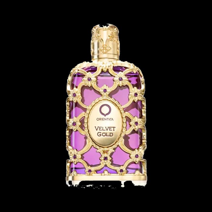 Frasco rectangular de vidrio violeta envuelto en filigrana dorada con cabujones morados y un medallón ovalado al frente, sobre fondo blanco.