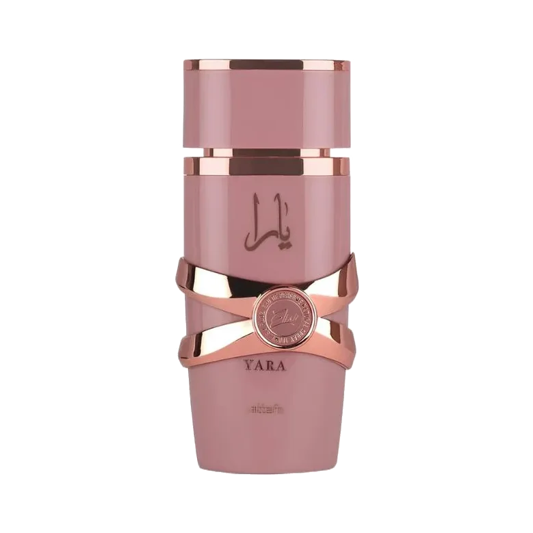 Frasco cilíndrico rosa palo de tapa escalonada, con cintas metálicas en oro rosa cruzadas sobre el cuerpo y un medallón circular al centro, sobre fondo blanco.