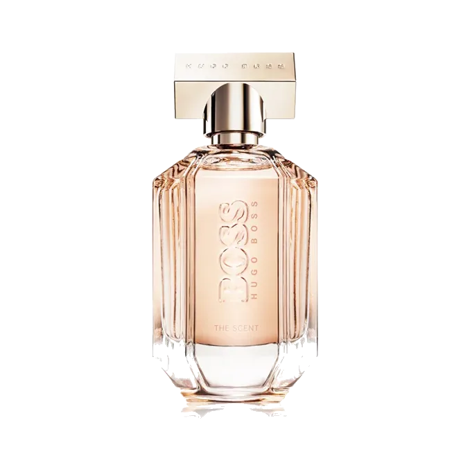 Frasco facetado de vidrio con degradado de rosa nude a transparente y tapa rectangular dorada, sobre fondo blanco.